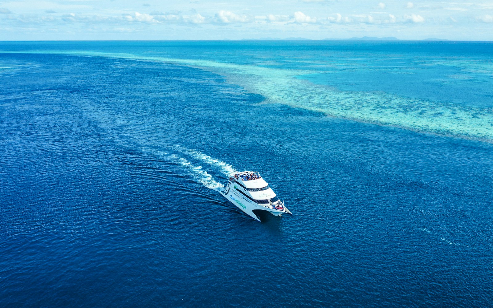 Cruise Whitsundays boat sailing on the Great Barrier Reef.
