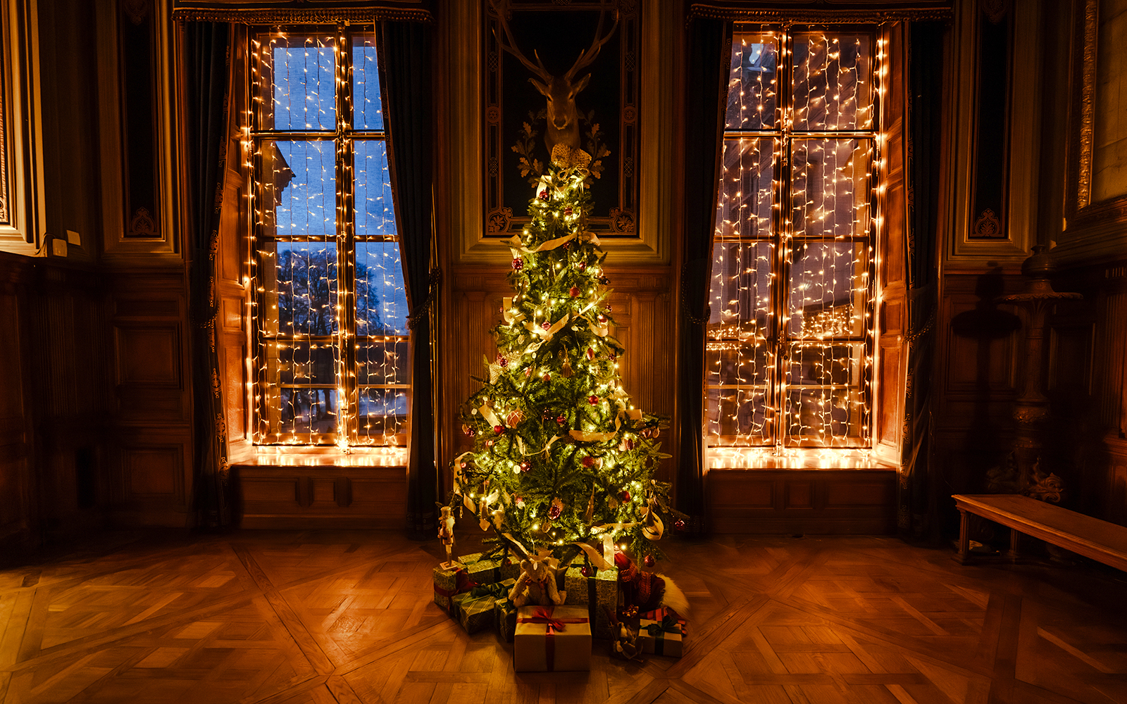 Christmas tree with lights and gifts at Chateau of Chantilly, France.
