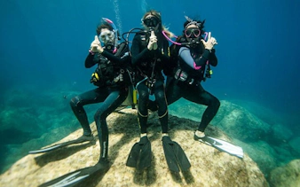 Scuba divers posing underwater during a guided dive in Sharm El Sheikh.