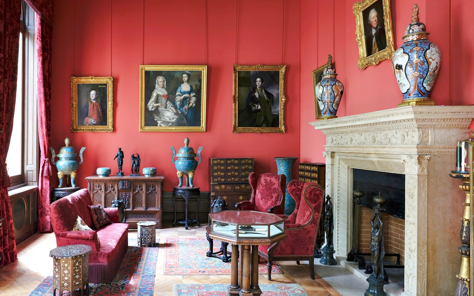 Jacquemart André Museum interior with ornate red walls, classic paintings, and antique furniture.