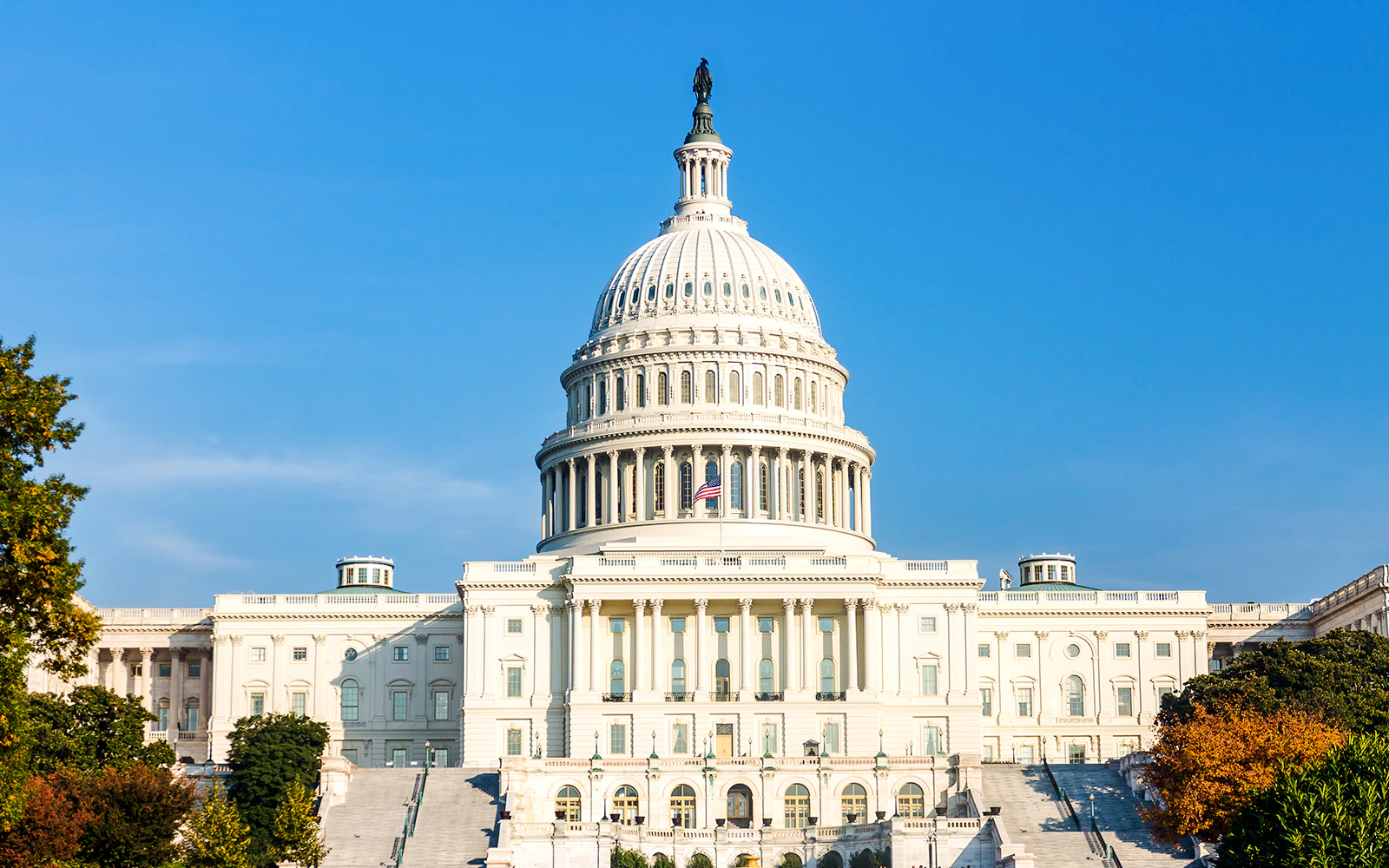 United States Capitol building under clear blue sky.