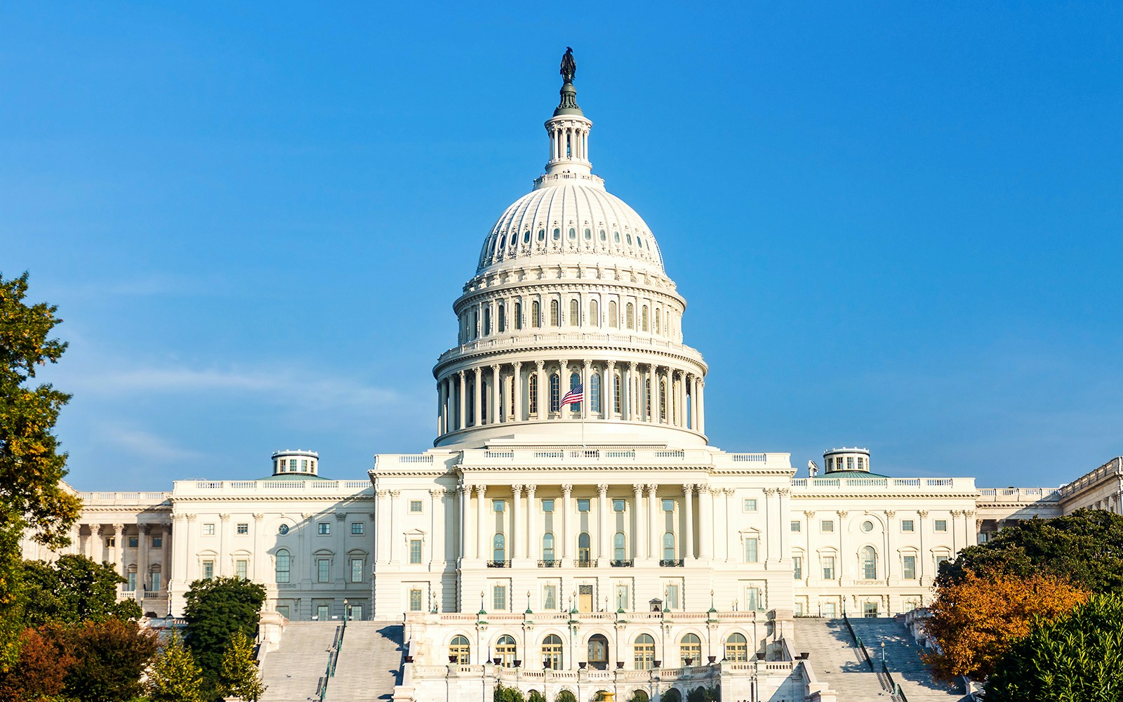 United States Capitol building under clear blue sky.
