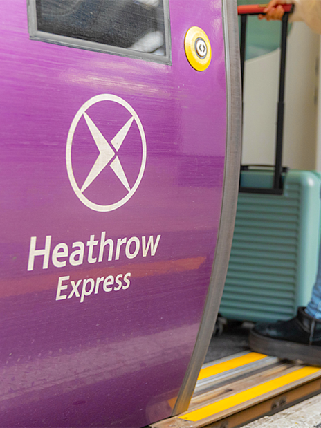 Heathrow Express train door with passenger boarding.