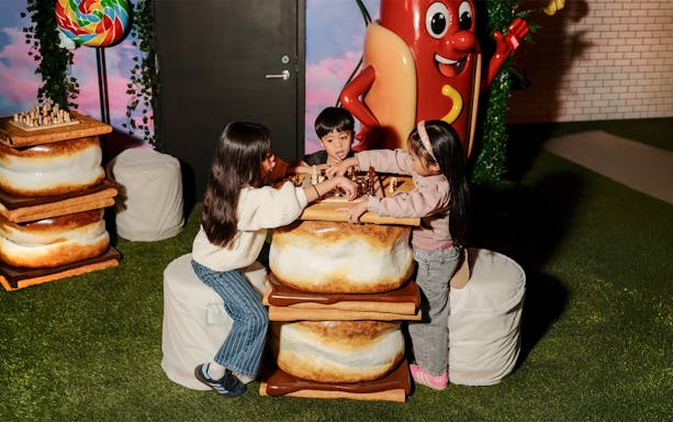 Children playing chess at a marshmallow-themed table in the iCandy Experience, NYC.