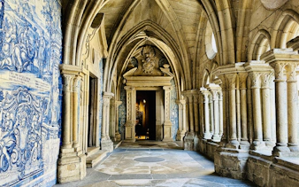 Porto Cathedral cloister with ornate arches and blue azulejo tiles.