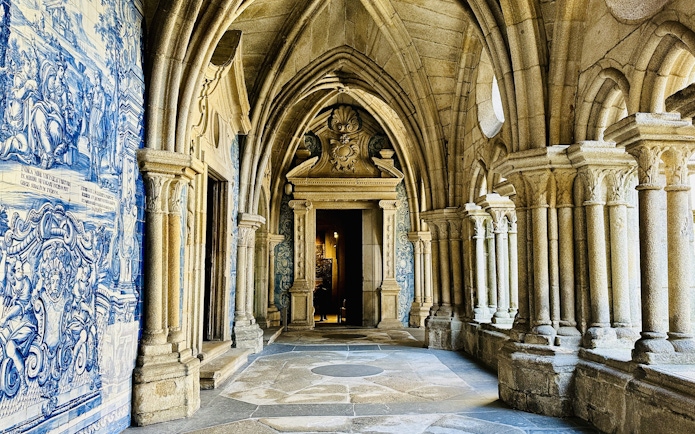 Porto Cathedral cloister with ornate arches and blue azulejo tiles.