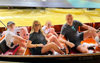Family enjoying a boat ride at a floating market on the Floating Market & Railway Market tour from Laem Chabang, Pattaya.