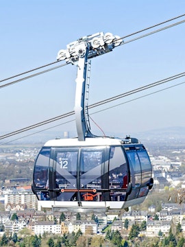 Koblenz cable car over cityscape with distant hills in Germany.