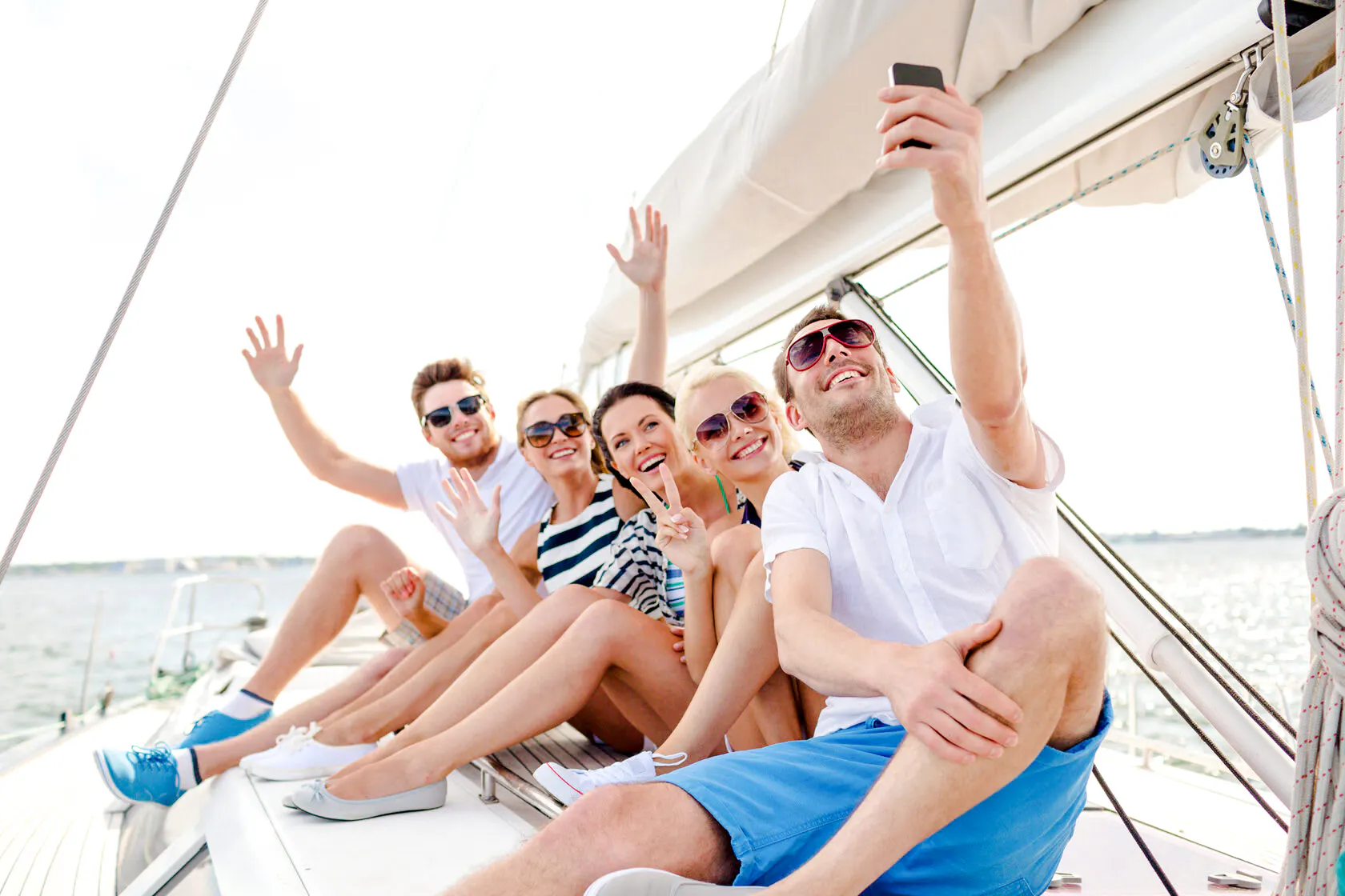 Group enjoying a boat trip on the ocean near Agadir, taking a selfie.