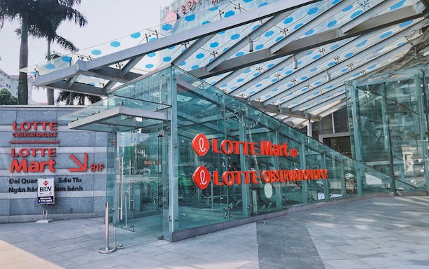 Entrance to Lotte Observation Deck in Hanoi, featuring glass architecture and signage.