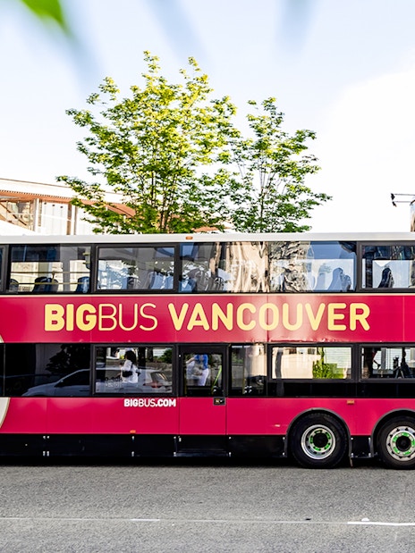 Double-decker tour bus labeled "Big Bus Vancouver" parked on a city street.