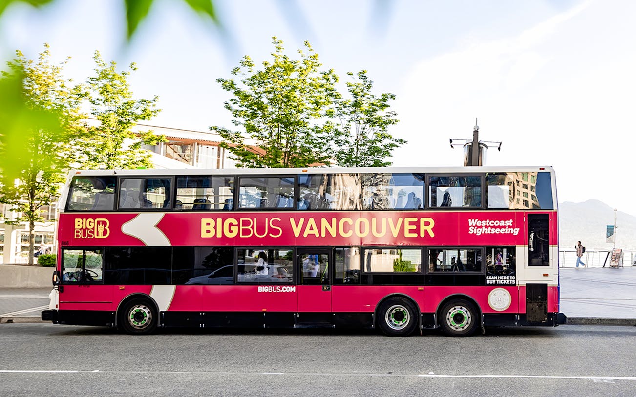 Double-decker tour bus labeled "Big Bus Vancouver" parked on a city street.