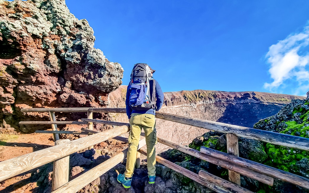 Hiker overlooking Mount Vesuvius crater in Naples, Italy.