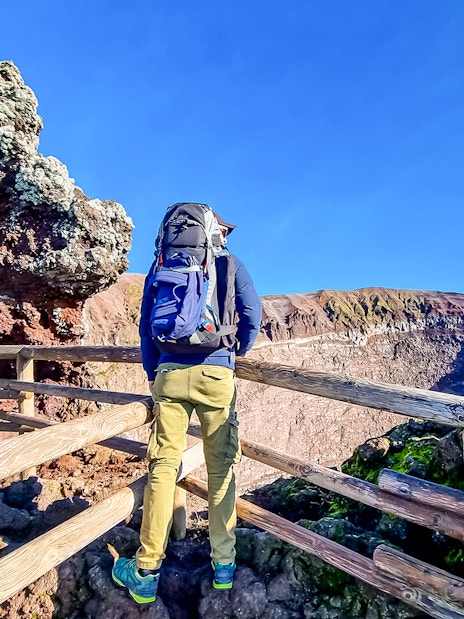 Hiker overlooking Mount Vesuvius crater in Naples, Italy.