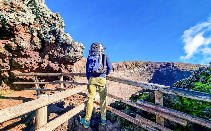 Hiker overlooking Mount Vesuvius crater in Naples, Italy.