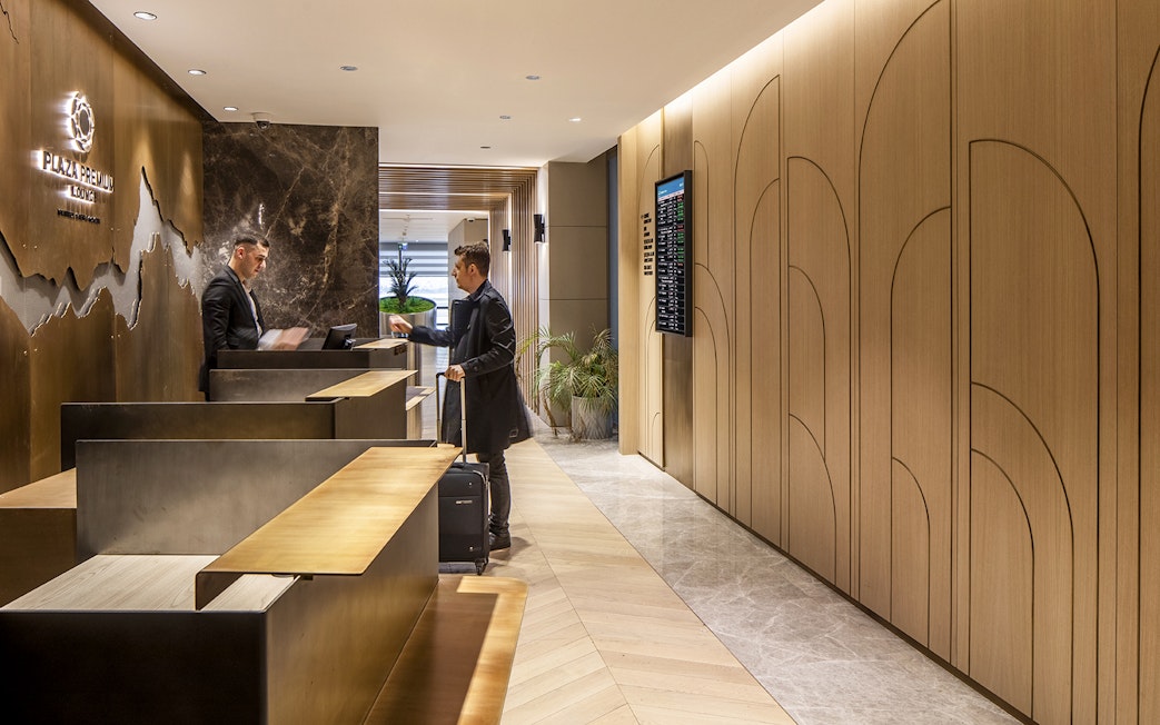 Plaza Premium lounge reception at Istanbul Ataturk Airport with guest checking in.