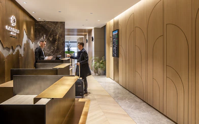 Plaza Premium lounge reception at Istanbul Ataturk Airport with guest checking in.