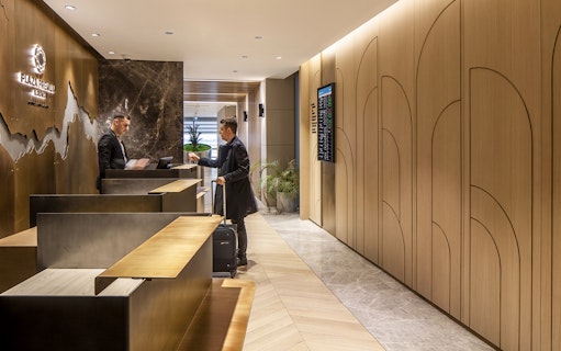 Plaza Premium lounge reception at Istanbul Ataturk Airport with guest checking in.
