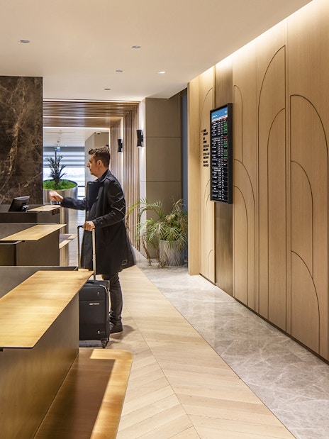 Plaza Premium lounge reception at Istanbul Ataturk Airport with guest checking in.