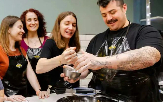 Cooking class participants preparing paella in Barcelona.