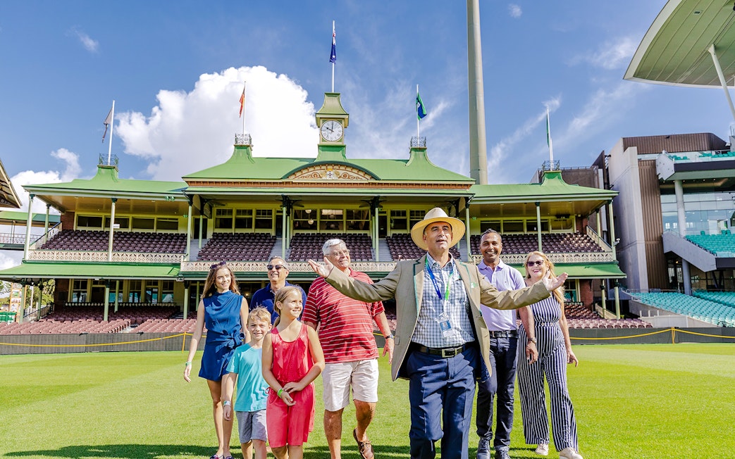 Tour group with guide at Sydney Cricket Ground stadium.