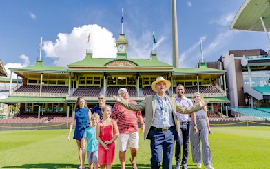 Tour group with guide at Sydney Cricket Ground stadium.