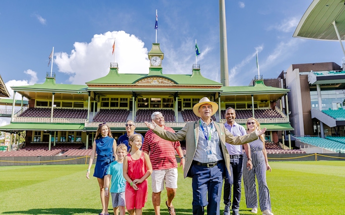 Tour group with guide at Sydney Cricket Ground stadium.