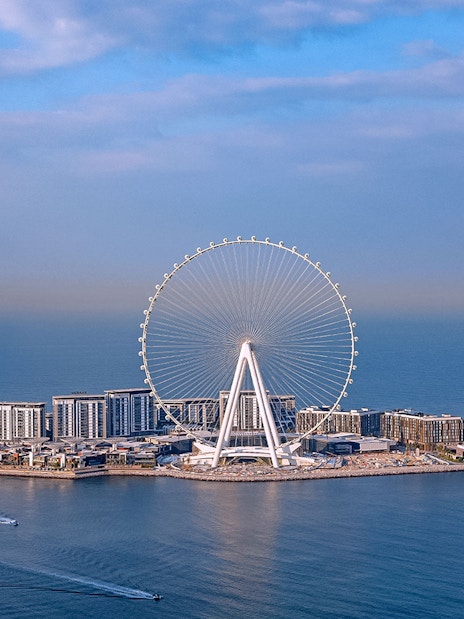 Ain Dubai Ferris wheel on Bluewaters Island, Dubai, with surrounding sea and skyline.