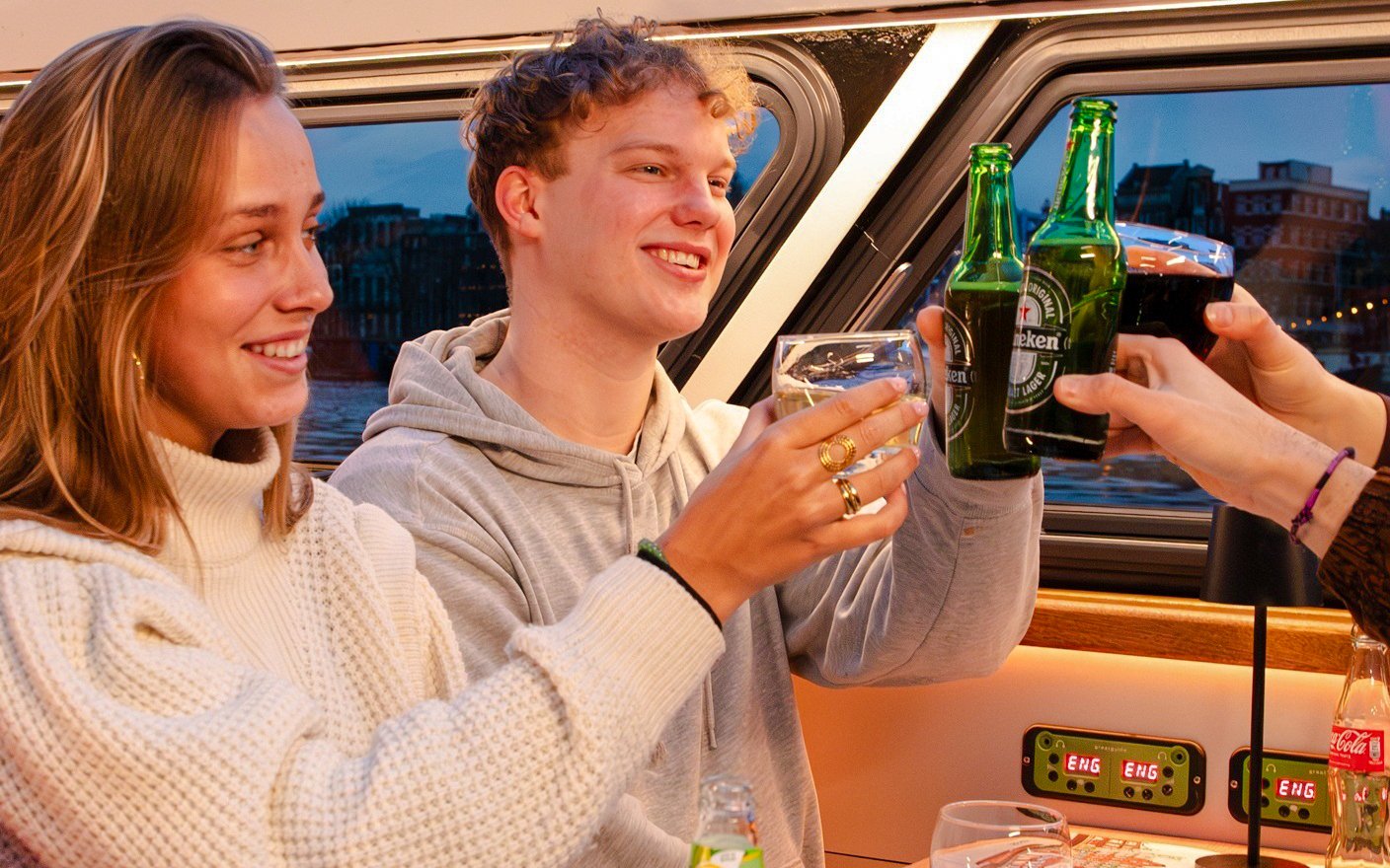 Guests enjoying drinks on the Lovers Canal Cruise in Amsterdam.
