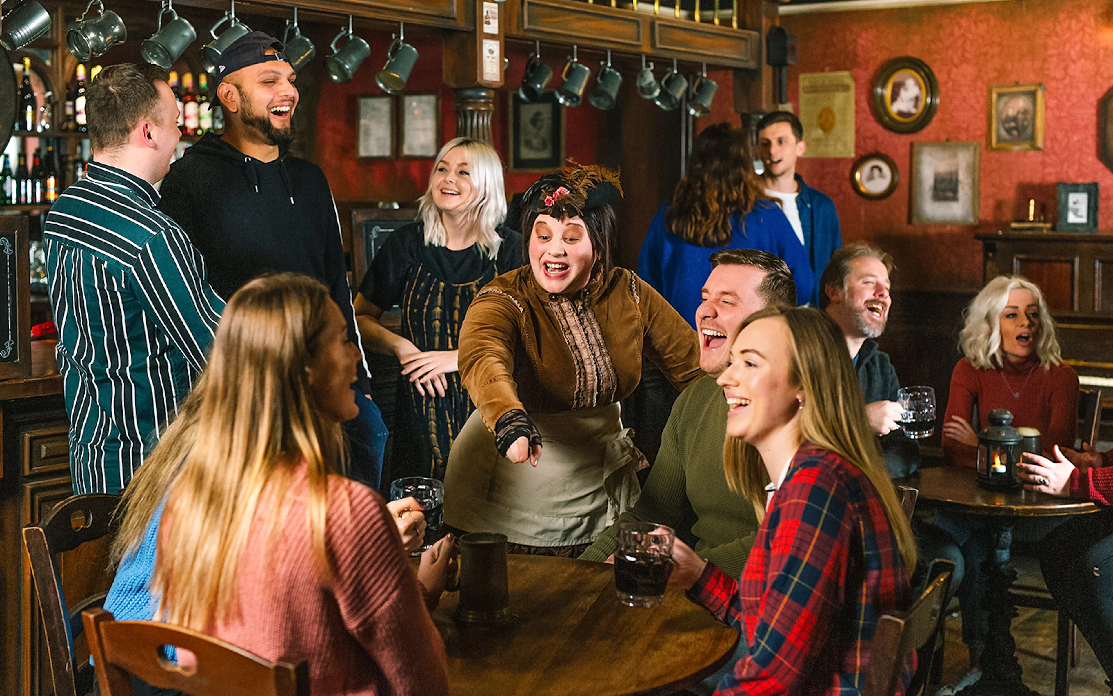 Visitors enjoying drinks with costumed characters at London Dungeon.