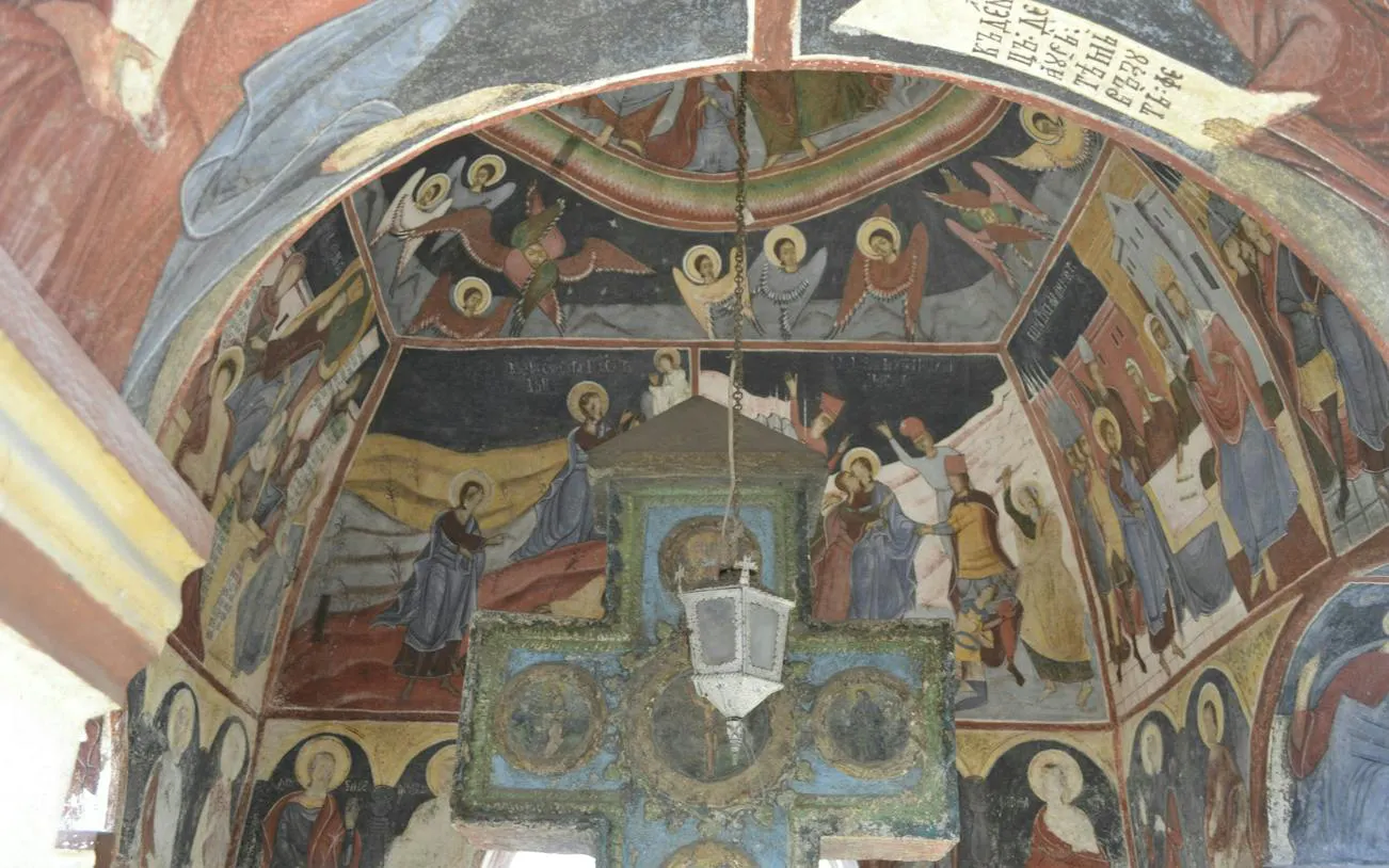 Frescoes inside a church in Schei, Brașov, depicting religious scenes and figures.