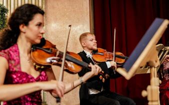 Violinists performing at the Imperial Gala Concert, Palais Auersperg, Vienna.