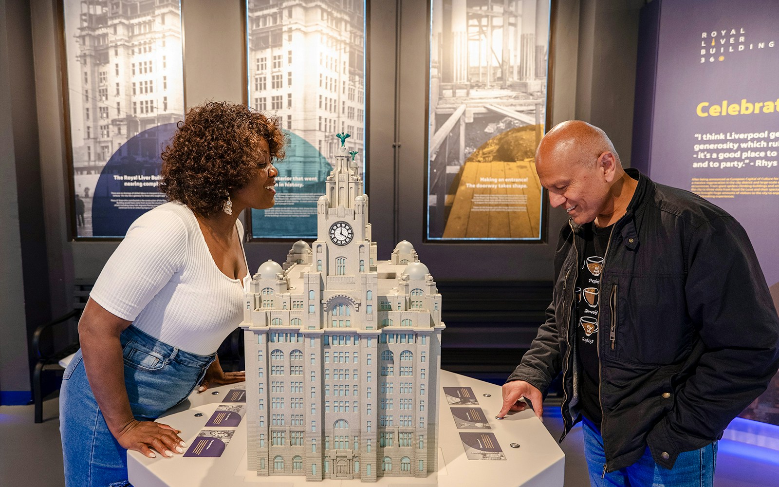 Guests examining a model of the Royal Liver Building exhibits.
