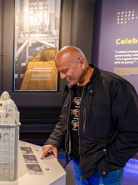 Guests examining a model of the Royal Liver Building exhibits.