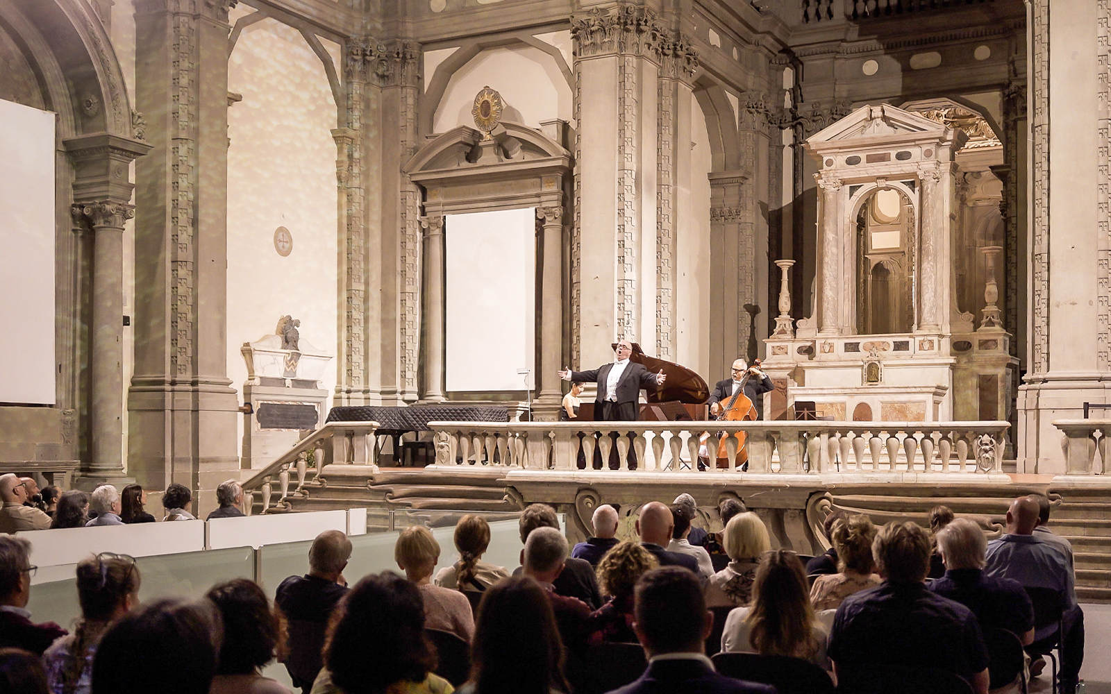 Three tenors performing in a historic Florence venue during a Tuscan dinner concert.