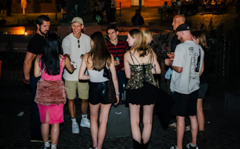 Group enjoying Düsseldorf nightlife tour with drinks and socializing.