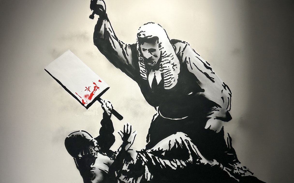 Judge with cleaver in Banksy artwork, featuring red paint splatter.