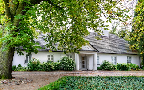 Chopin's birthplace in Zelazowa Wola, surrounded by lush greenery.