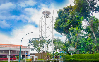 Skyhelix tower at Imbiah Lookout surrounded by trees, Sentosa, Singapore.