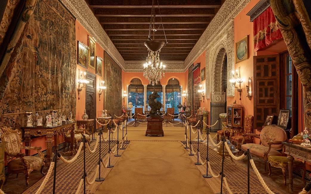 Palacio de las Dueñas interior with ornate decor and chandeliers, Seville.