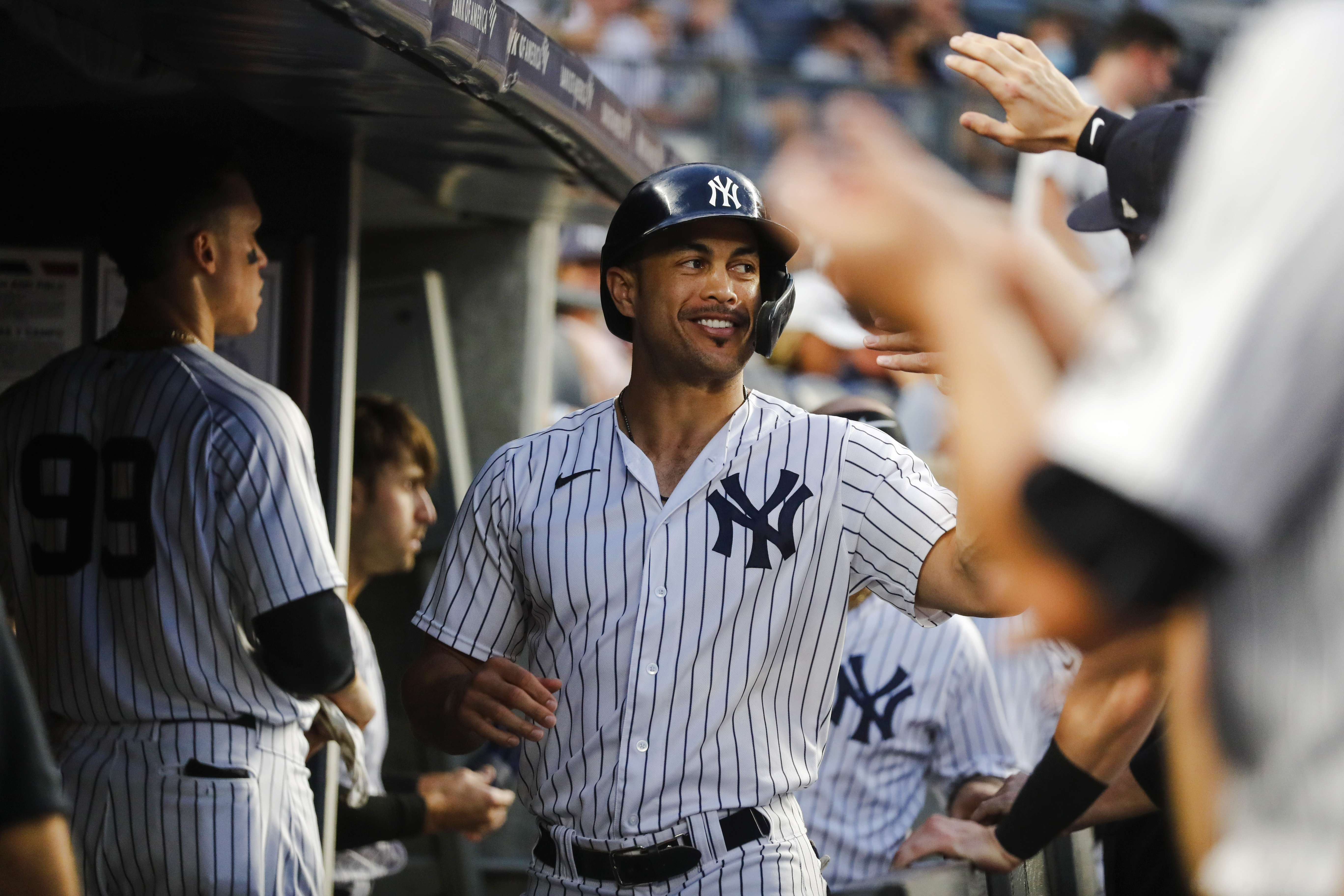 Yankees player celebrating in the dugout during a game.