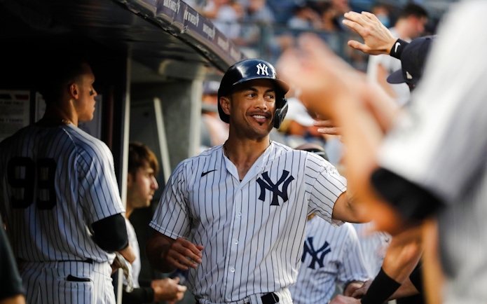 Yankees player celebrating in the dugout during a game.