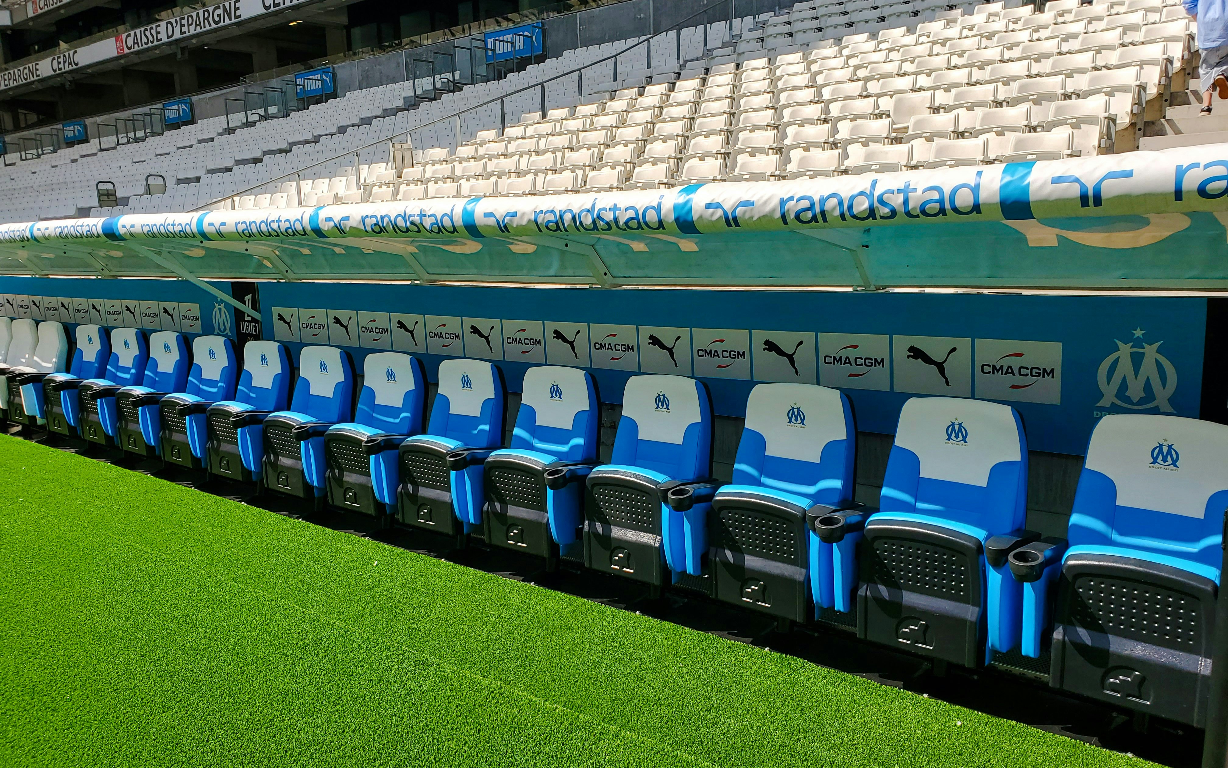 Team benches at Orange Vélodrome stadium in Marseille, France.