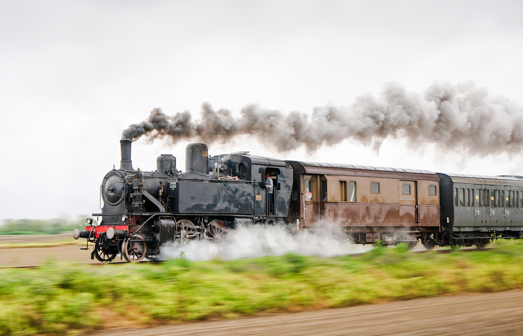 Vintage steam train running on a track