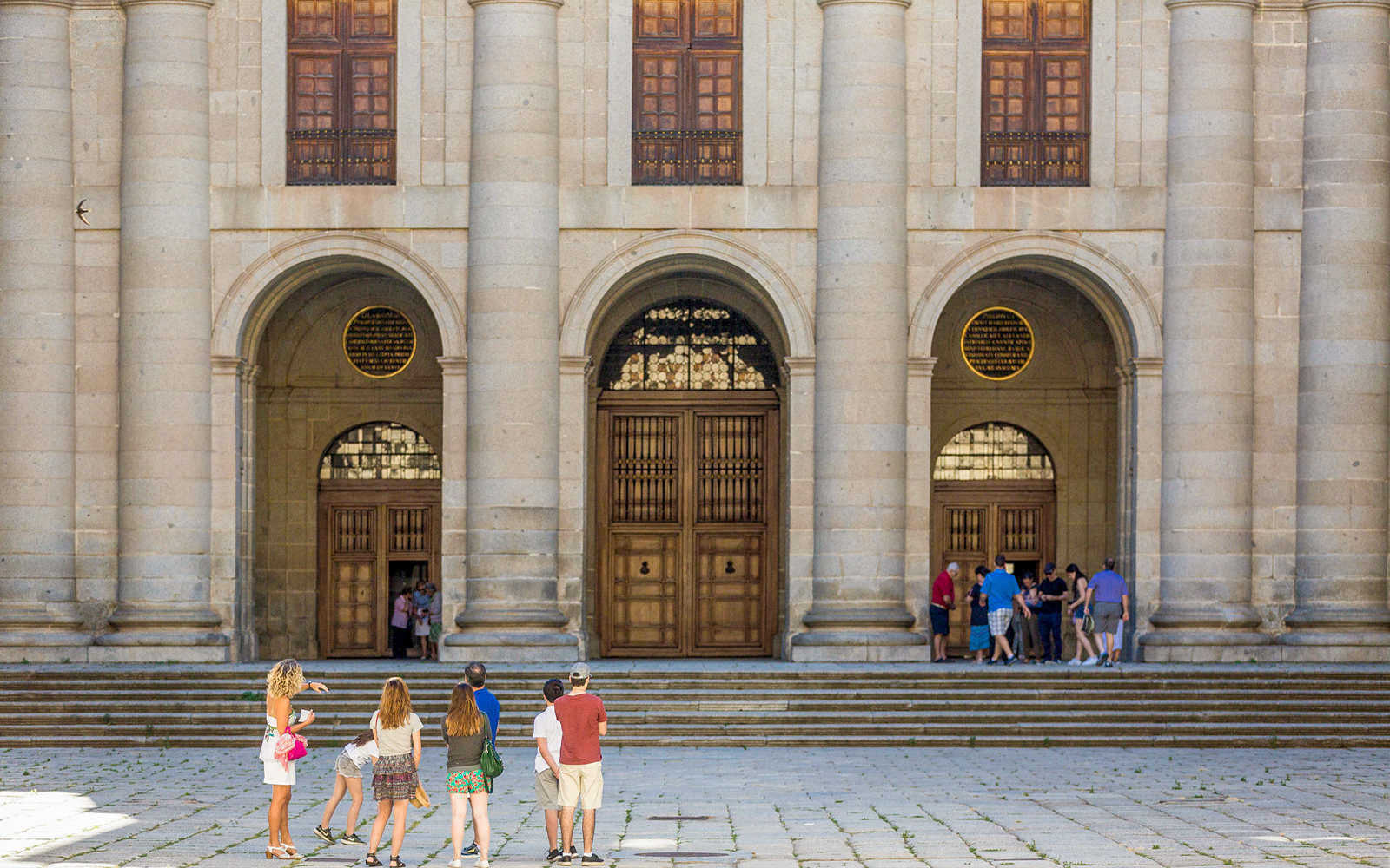 Tour guide at San Lorenzo de El Escorial entrance, Spain.