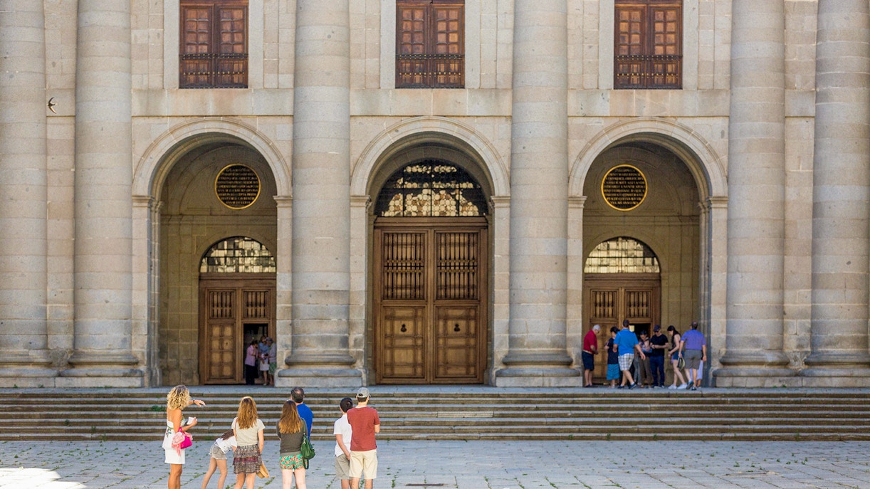 Tour guide at San Lorenzo de El Escorial entrance, Spain.