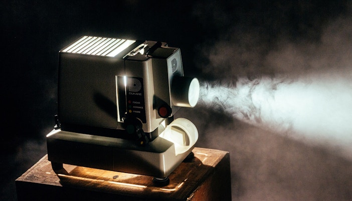 Vintage cinema interior with red velvet seats and ornate ceiling in Paris, France.