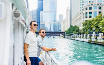 Cruise passengers enjoying views of Chicago skyline along the river.