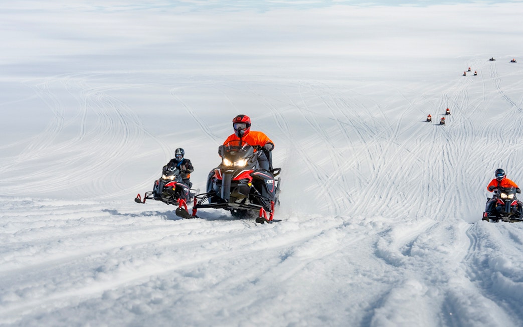 Snowmobile riders on Langjökull glacier tour in Iceland.