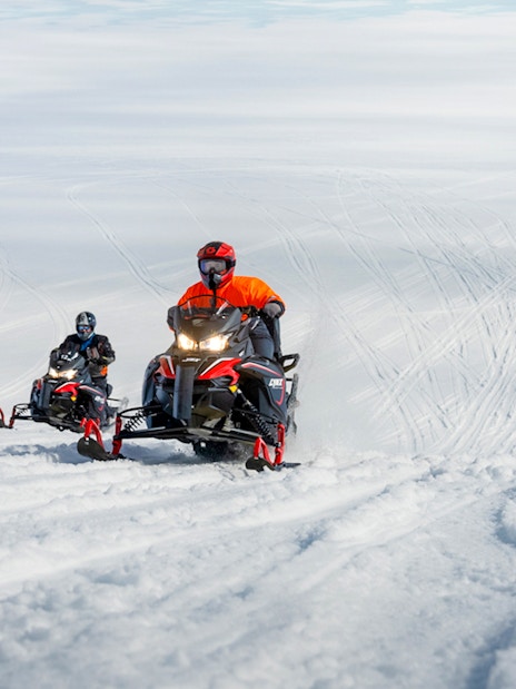 Snowmobile riders on Langjökull glacier tour in Iceland.